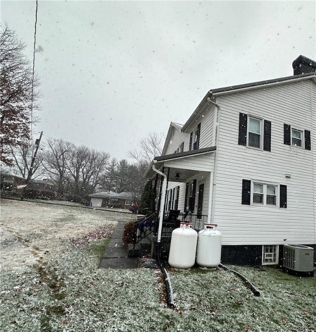 view of property exterior featuring covered porch and central air condition unit