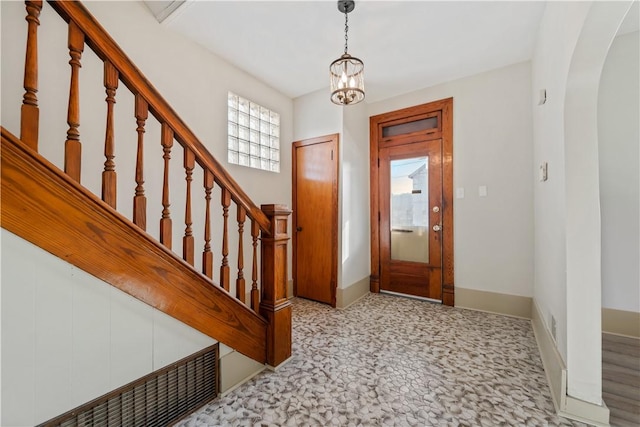 entryway with a chandelier