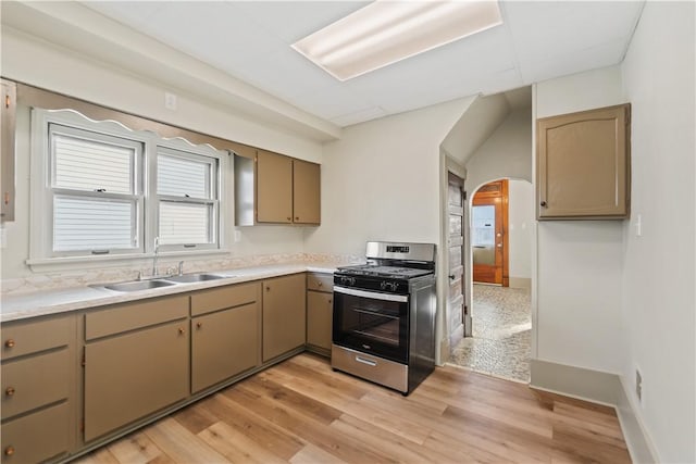 kitchen featuring light wood-type flooring, sink, and gas range