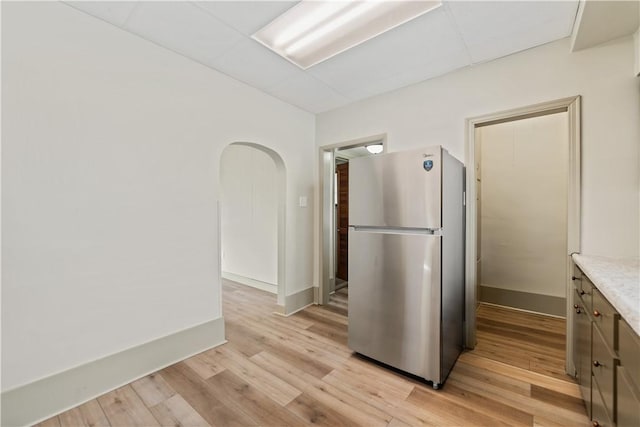 kitchen featuring light wood-type flooring and stainless steel refrigerator