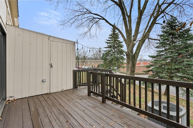 wooden deck featuring central AC unit