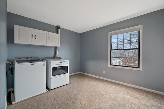 laundry area with baseboards, separate washer and dryer, cabinet space, and light colored carpet