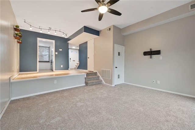 carpeted spare room with visible vents and baseboards