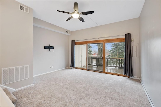 carpeted spare room with ceiling fan, visible vents, and baseboards