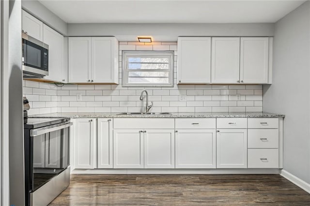 kitchen with white cabinets, stainless steel appliances, dark wood-type flooring, and sink