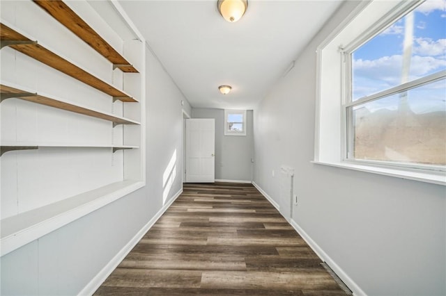 hallway with dark hardwood / wood-style floors