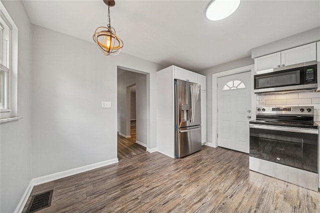 kitchen featuring white cabinets, dark hardwood / wood-style floors, decorative backsplash, and stainless steel appliances