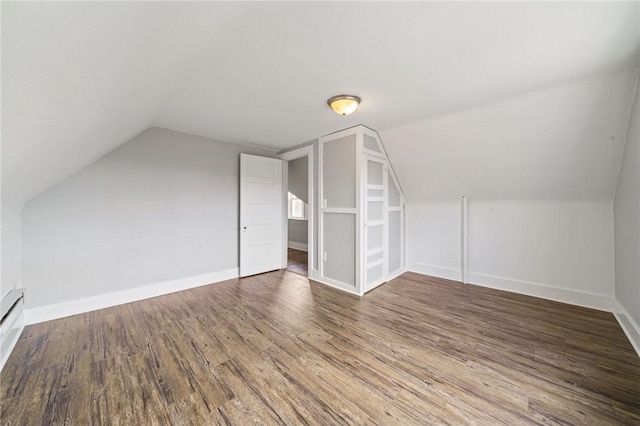 additional living space with lofted ceiling and dark wood-type flooring