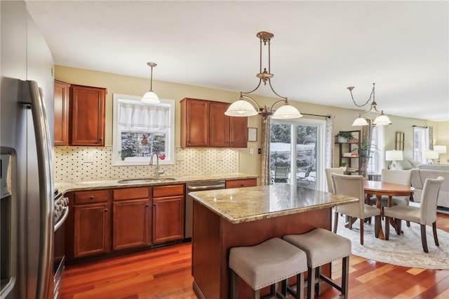 kitchen featuring sink, pendant lighting, dark hardwood / wood-style floors, and appliances with stainless steel finishes