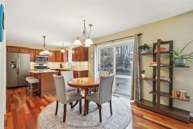 dining space with sink and dark wood-type flooring