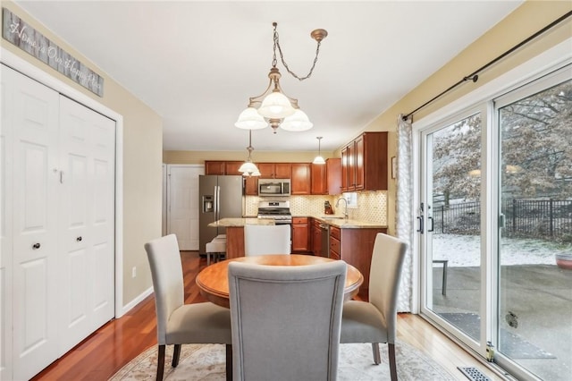 dining room with sink and light hardwood / wood-style flooring