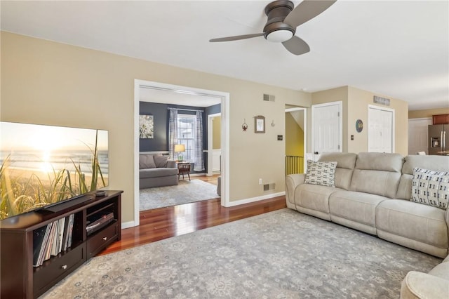 living room with ceiling fan and wood-type flooring