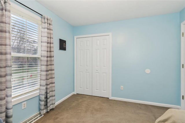 unfurnished bedroom with light carpet and a closet