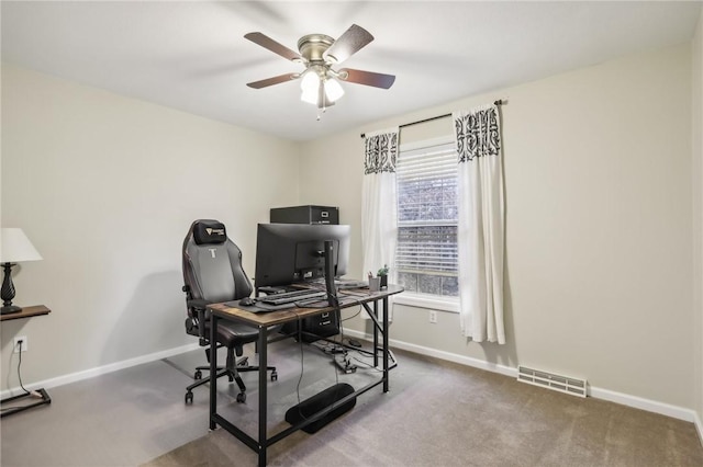 carpeted office featuring ceiling fan