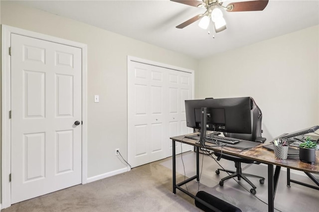 carpeted home office with ceiling fan