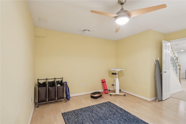 workout area with hardwood / wood-style floors and ceiling fan