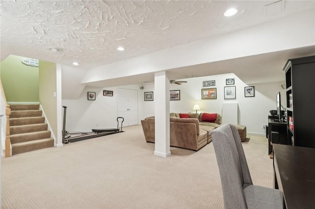 carpeted living room featuring a textured ceiling