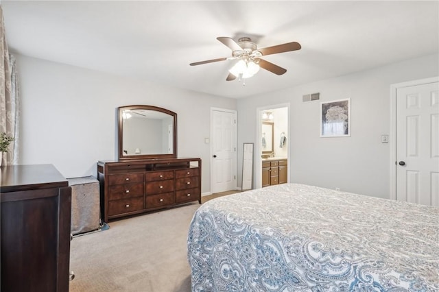 carpeted bedroom with ceiling fan and ensuite bathroom