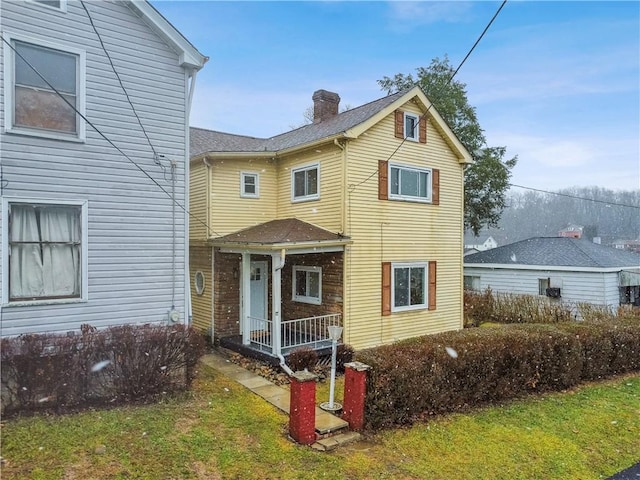 view of property featuring a front lawn