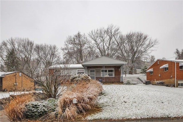 bungalow with covered porch and central air condition unit