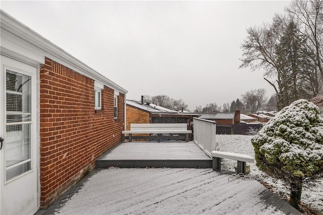 snow covered property with a wooden deck