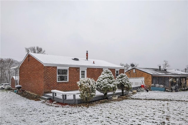 view of snow covered rear of property