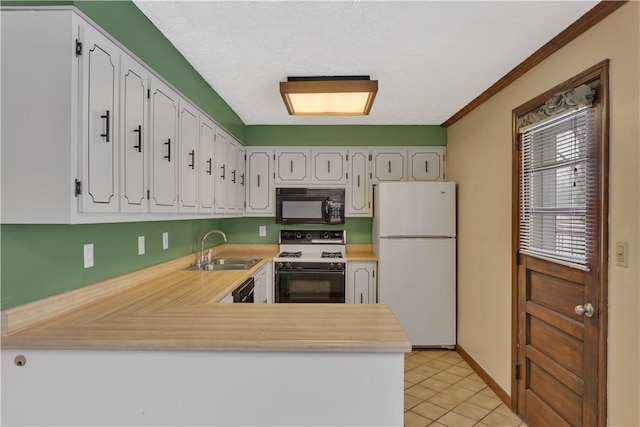 kitchen featuring crown molding, sink, black appliances, light tile patterned floors, and white cabinets