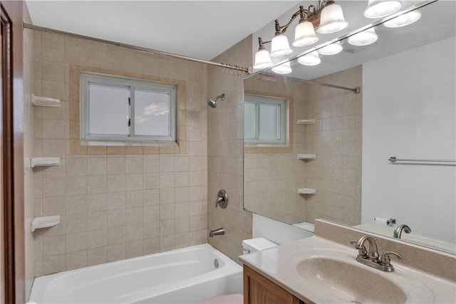 full bathroom with vanity, toilet, and tiled shower / bath combo