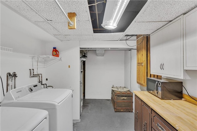 laundry area with cabinets and independent washer and dryer