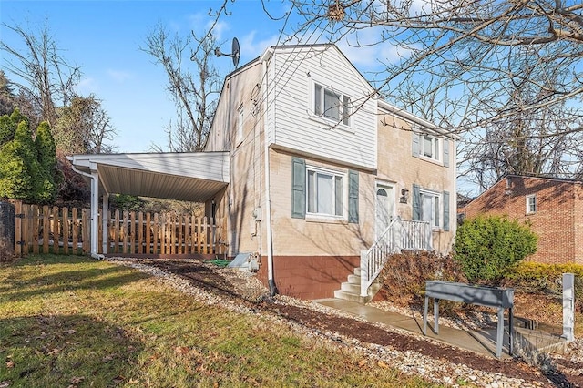 exterior space with fence and a front lawn