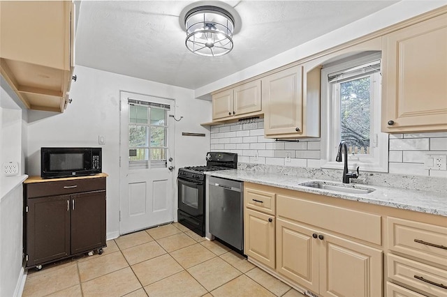 kitchen with sink, backsplash, black appliances, and light stone countertops