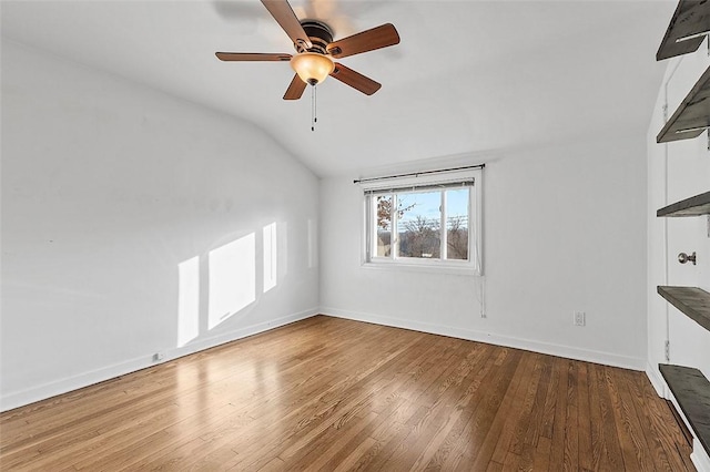 unfurnished living room featuring vaulted ceiling, hardwood / wood-style floors, and ceiling fan