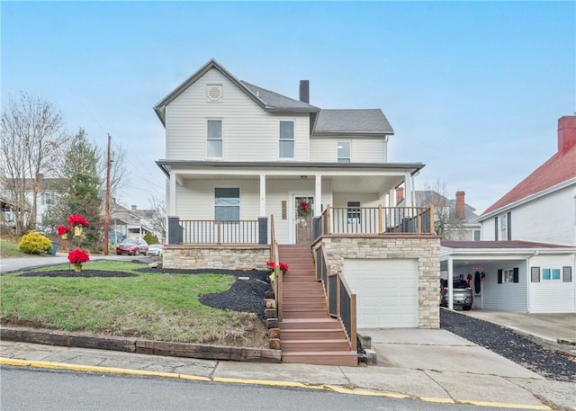 view of front facade with a porch, a garage, a front yard, and a carport