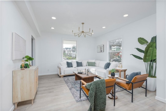 living room featuring a chandelier and light hardwood / wood-style flooring