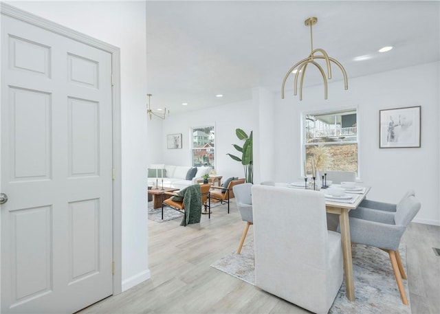 dining room featuring light hardwood / wood-style floors and a notable chandelier