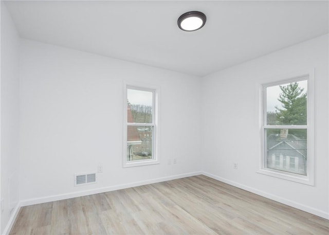 spare room featuring light wood-type flooring