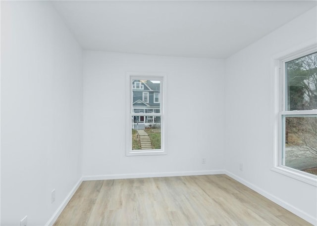 empty room featuring light hardwood / wood-style flooring and a healthy amount of sunlight