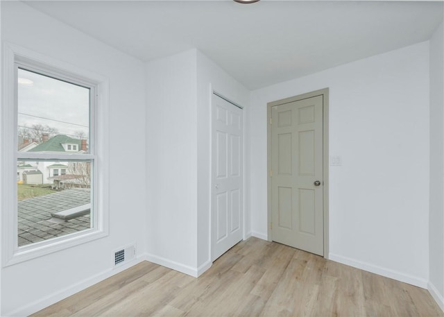 spare room with light hardwood / wood-style flooring