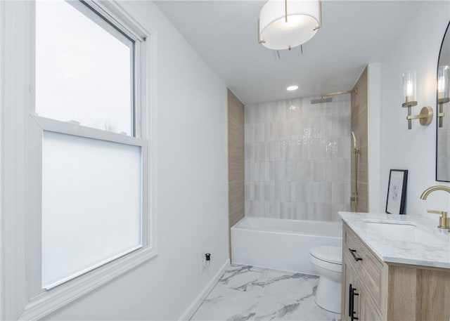 full bathroom featuring vanity, a healthy amount of sunlight, tiled shower / bath combo, and toilet