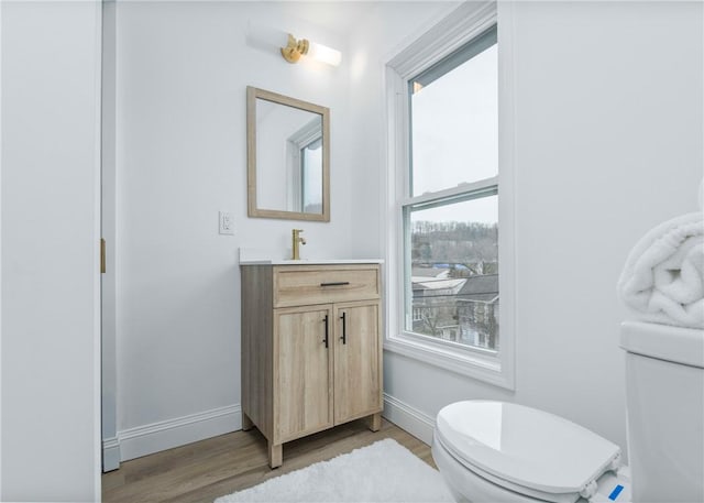 bathroom featuring hardwood / wood-style floors, vanity, and toilet