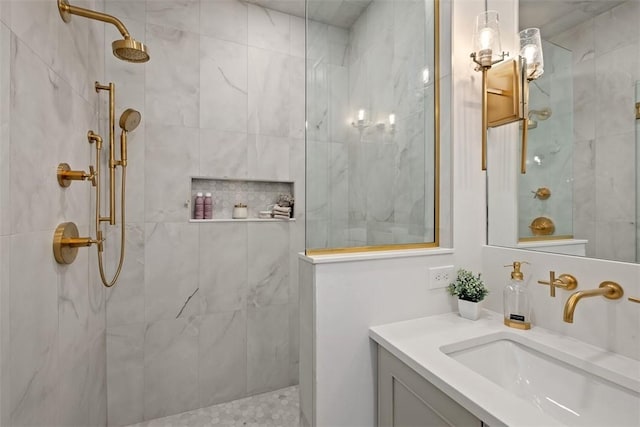 bathroom featuring vanity and tiled shower