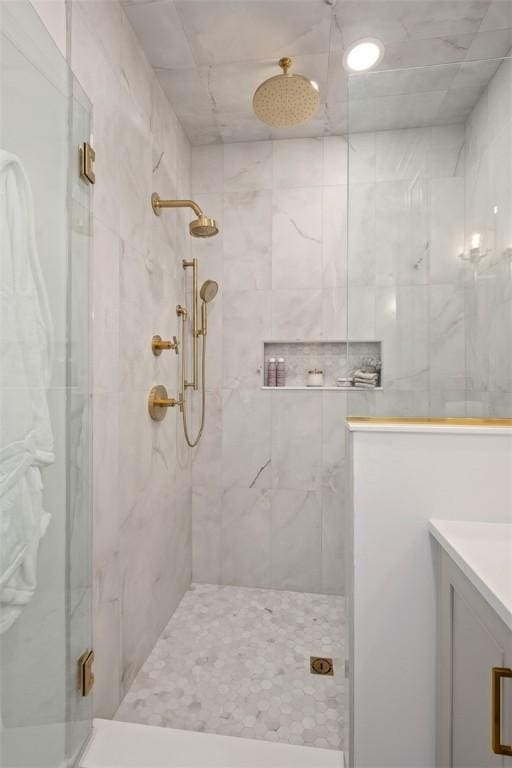 bathroom featuring vanity and a shower with shower door