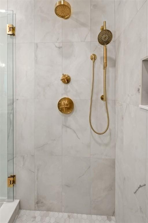 bathroom with a tile shower