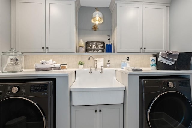 washroom featuring washing machine and dryer and sink