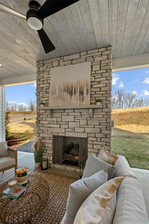 exterior space with an outdoor living space with a fireplace and ceiling fan