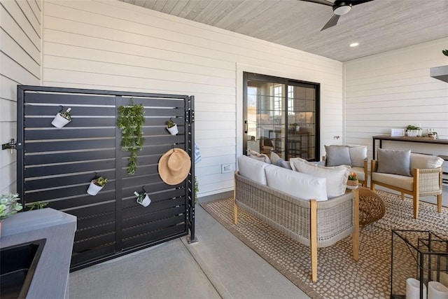 view of patio / terrace with ceiling fan and an outdoor living space