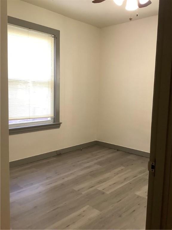 empty room featuring ceiling fan and wood-type flooring