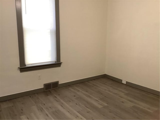 spare room featuring hardwood / wood-style floors