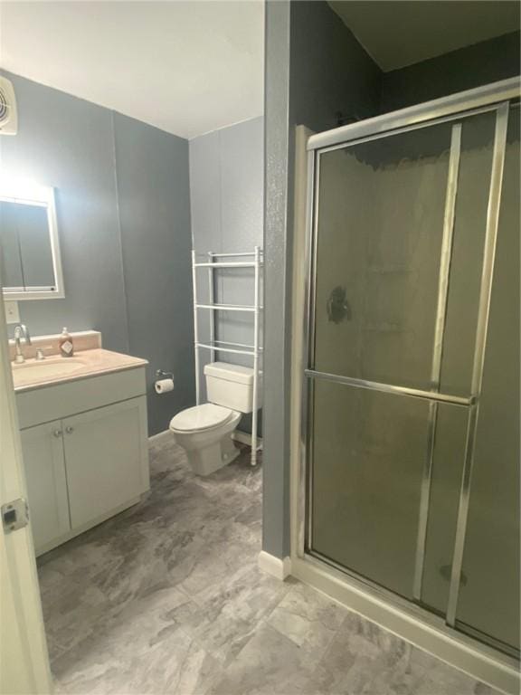 bathroom with vanity, toilet, and walk in shower