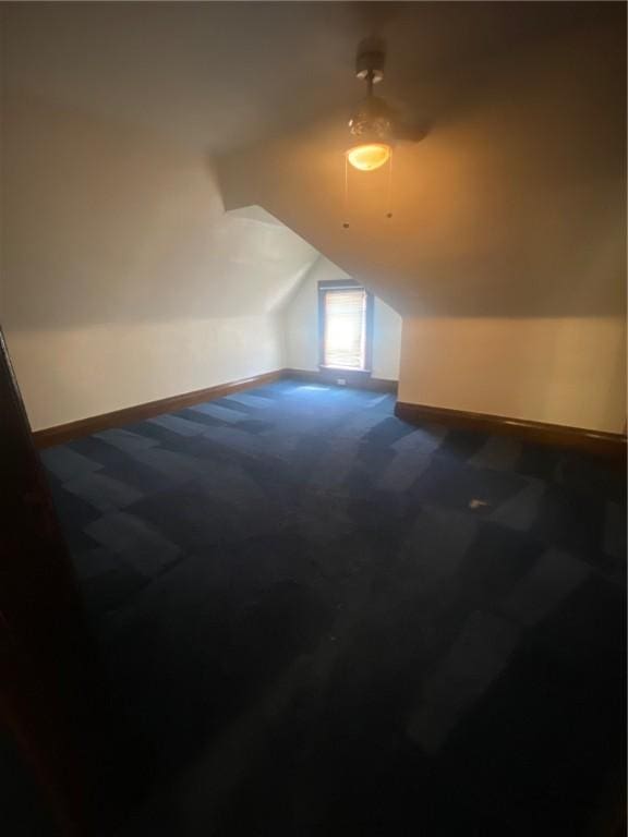 bonus room with carpet and vaulted ceiling